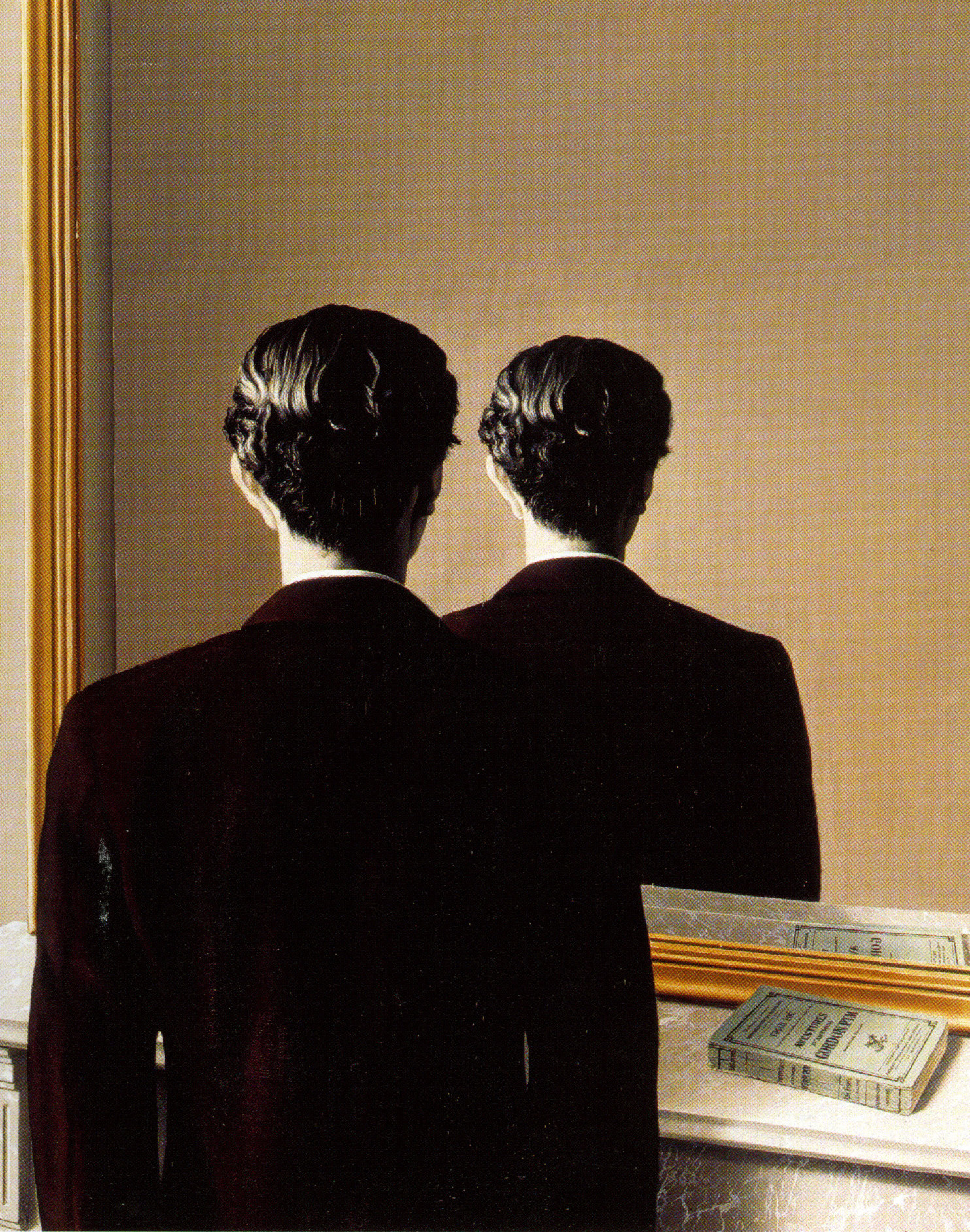 A man faces a mirror that reflects the back of his head instead of his face.