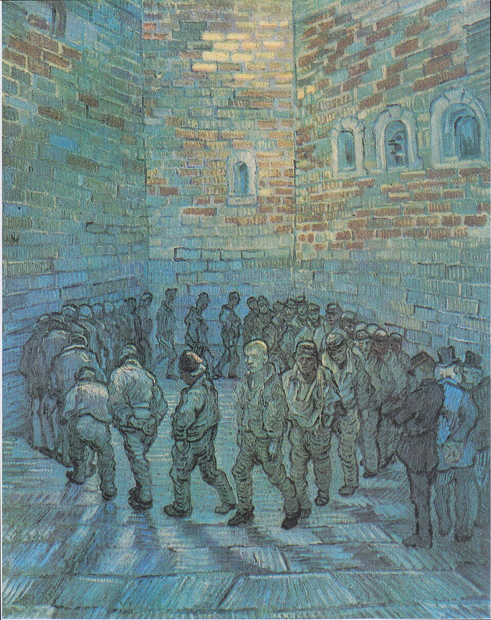 Prisoners walk in a tight circle beneath high brick walls.